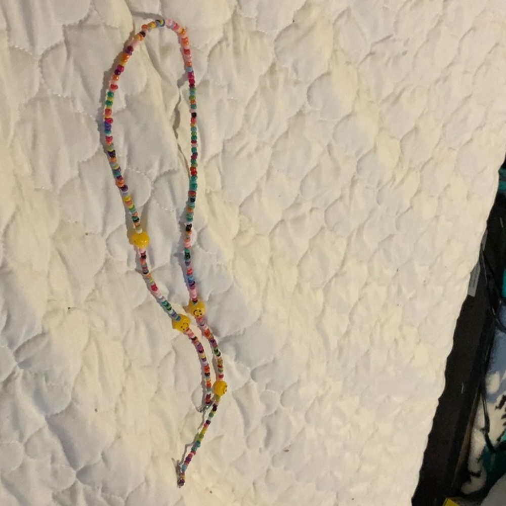 I am selling a multi colored necklace with smiley faces.